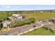 Aerial view of community with long grass and a neighborhood center at 3912 Avalon Park West Blvd, Orlando, FL 32828