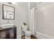 Bright bathroom featuring tile shower, modern vanity, and decorative mirror at 3912 Avalon Park West Blvd, Orlando, FL 32828