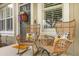 Inviting front porch with wicker rocking chairs and decorative pillows and seasonal door decor at 3912 Avalon Park West Blvd, Orlando, FL 32828