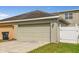 Two car garage is attached to the home with driveway and grassy area at 3912 Avalon Park West Blvd, Orlando, FL 32828