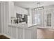 Updated kitchen featuring stainless steel appliances, white cabinetry, and a breakfast bar at 3912 Avalon Park West Blvd, Orlando, FL 32828