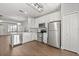 Contemporary kitchen with white cabinets, stainless steel appliances, and hardwood flooring at 3912 Avalon Park West Blvd, Orlando, FL 32828
