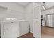 Laundry room with shelving, washer, dryer, and access to kitchen at 3912 Avalon Park West Blvd, Orlando, FL 32828