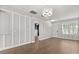 Bright and airy living room featuring hardwood floors, stylish accent wall, and natural light at 3912 Avalon Park West Blvd, Orlando, FL 32828