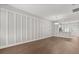 Spacious living room showcases hardwood floors, white accent wall, and seamless flow into the kitchen at 3912 Avalon Park West Blvd, Orlando, FL 32828
