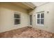 Covered brick patio is the perfect place to relax with windows and a glass paned door at 3912 Avalon Park West Blvd, Orlando, FL 32828