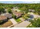 Aerial view of property showcasing the home, landscaping, surrounding neighborhood, and a solar panel-equipped home nearby at 400 Woodview Dr, Longwood, FL 32779