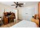Bedroom featuring a ceiling fan, laminate wood flooring, and a spacious closet at 400 Woodview Dr, Longwood, FL 32779