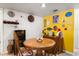 Dining area featuring a wooden table and chairs, a wine rack, and a yellow accent wall at 400 Woodview Dr, Longwood, FL 32779