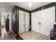 Hallway featuring tile floors, coat closet, and access to other rooms, illuminated by a modern light fixture at 400 Woodview Dr, Longwood, FL 32779