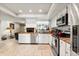 Bright kitchen with stainless steel appliances, ample cabinet space, and tile flooring at 400 Woodview Dr, Longwood, FL 32779