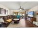 Spacious living room featuring a comfortable sectional sofa, ceiling fan, and sliding glass doors to the patio at 400 Woodview Dr, Longwood, FL 32779