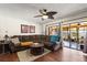 Comfortable living room features a ceiling fan, sliding glass doors to the patio, and a plush sectional sofa at 400 Woodview Dr, Longwood, FL 32779