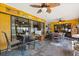 Enclosed patio with tile flooring, multiple ceiling fans, and outdoor dining furniture at 400 Woodview Dr, Longwood, FL 32779