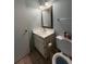 Bathroom featuring white vanity, decorative mirror, and light blue walls at 402 Dorchester Sq, Lake Mary, FL 32746