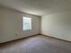 Spacious bedroom with neutral carpet and natural light from a bright window at 402 Dorchester Sq, Lake Mary, FL 32746