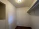 Bright, carpeted walk-in closet offering a shelf for storage at 402 Dorchester Sq, Lake Mary, FL 32746