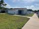 Exterior view of a one-story unit with a white picket fence and green lawn at 402 Dorchester Sq, Lake Mary, FL 32746