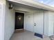 View of front door adorned with wreath and welcome mat at 402 Dorchester Sq, Lake Mary, FL 32746