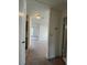 Open hallway with neutral carpet offers a glimpse into the adjacent rooms at 402 Dorchester Sq, Lake Mary, FL 32746