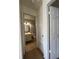 Hallway view of bathroom with white vanity, toilet and tile floor at 402 Dorchester Sq, Lake Mary, FL 32746