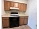 Features include an electric range with overhead vent and ample countertop space at 402 Dorchester Sq, Lake Mary, FL 32746