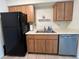Kitchen includes stainless steel dishwasher, a double sink, and wooden cabinets at 402 Dorchester Sq, Lake Mary, FL 32746