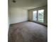 Large living room offering neutral carpet and plenty of light at 402 Dorchester Sq, Lake Mary, FL 32746