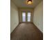 Spacious room featuring carpet and sliding glass doors to the backyard at 402 Dorchester Sq, Lake Mary, FL 32746
