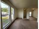 Bright living room with large windows and neutral carpeting at 402 Dorchester Sq, Lake Mary, FL 32746
