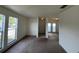 Cozy living room with carpet, front windows, and entrance to other rooms at 402 Dorchester Sq, Lake Mary, FL 32746