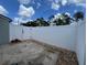 Private patio area with white fence, landscaping rocks, and access gate at 402 Dorchester Sq, Lake Mary, FL 32746