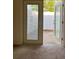 Carpeted room with glass panel door leading to a fenced patio with small rocks at 402 Dorchester Sq, Lake Mary, FL 32746