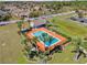 Aerial view of a community pool surrounded by lounge chairs and lush landscaping at 402 Dorchester Sq, Lake Mary, FL 32746