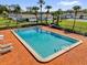 Community pool with deck chairs and well-manicured landscaping at 402 Dorchester Sq, Lake Mary, FL 32746