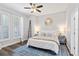 Serene bedroom with sunburst mirror and a comfortable queen-sized bed, inviting relaxation at 4094 Oak St, Orlando, FL 32814