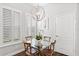 Cozy dining area with chandelier lighting and plantation shutters for a bright ambiance at 4094 Oak St, Orlando, FL 32814