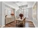 Spacious dining room with tray ceilings, hardwood floors, and stylish chandelier at 4094 Oak St, Orlando, FL 32814