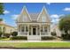 Charming two-story home with a inviting front porch and manicured lawn at 4094 Oak St, Orlando, FL 32814