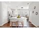 Open-concept kitchen with white cabinets, quartz countertops and a stylish dining area at 4094 Oak St, Orlando, FL 32814