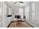 Well-lit home office featuring custom built-ins, modern desk, and plantation shutters at 4094 Oak St, Orlando, FL 32814