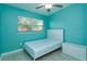 Bedroom features a comfortable bed, tile floors, and bright blue walls at 411 Hibiscus Rd, Casselberry, FL 32707