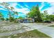 Charming one-story home with a large driveway and well-maintained landscaping at 411 Hibiscus Rd, Casselberry, FL 32707