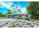 Charming single-story home with a carport, well-maintained landscaping, and a freshly painted exterior at 411 Hibiscus Rd, Casselberry, FL 32707