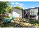 Full backyard view with fire pit, patio, furniture and exterior of home at 485 Sandpiper Ridge Dr, Orlando, FL 32835