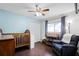 Cozy bedroom with hardwood floors, a ceiling fan, and a large window at 485 Sandpiper Ridge Dr, Orlando, FL 32835