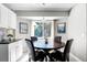 Eat-in kitchen featuring a dark wood table, chairs and natural light from a large window at 485 Sandpiper Ridge Dr, Orlando, FL 32835