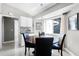 Eat-in kitchen area featuring a wood table, four chairs and natural light from a large window at 485 Sandpiper Ridge Dr, Orlando, FL 32835