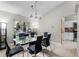 The dining room showcases a glass table, black chairs, and a view of the outdoors through a large window at 485 Sandpiper Ridge Dr, Orlando, FL 32835