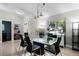 Bright dining room features a modern glass table, black chairs, and ample natural light from a large window at 485 Sandpiper Ridge Dr, Orlando, FL 32835